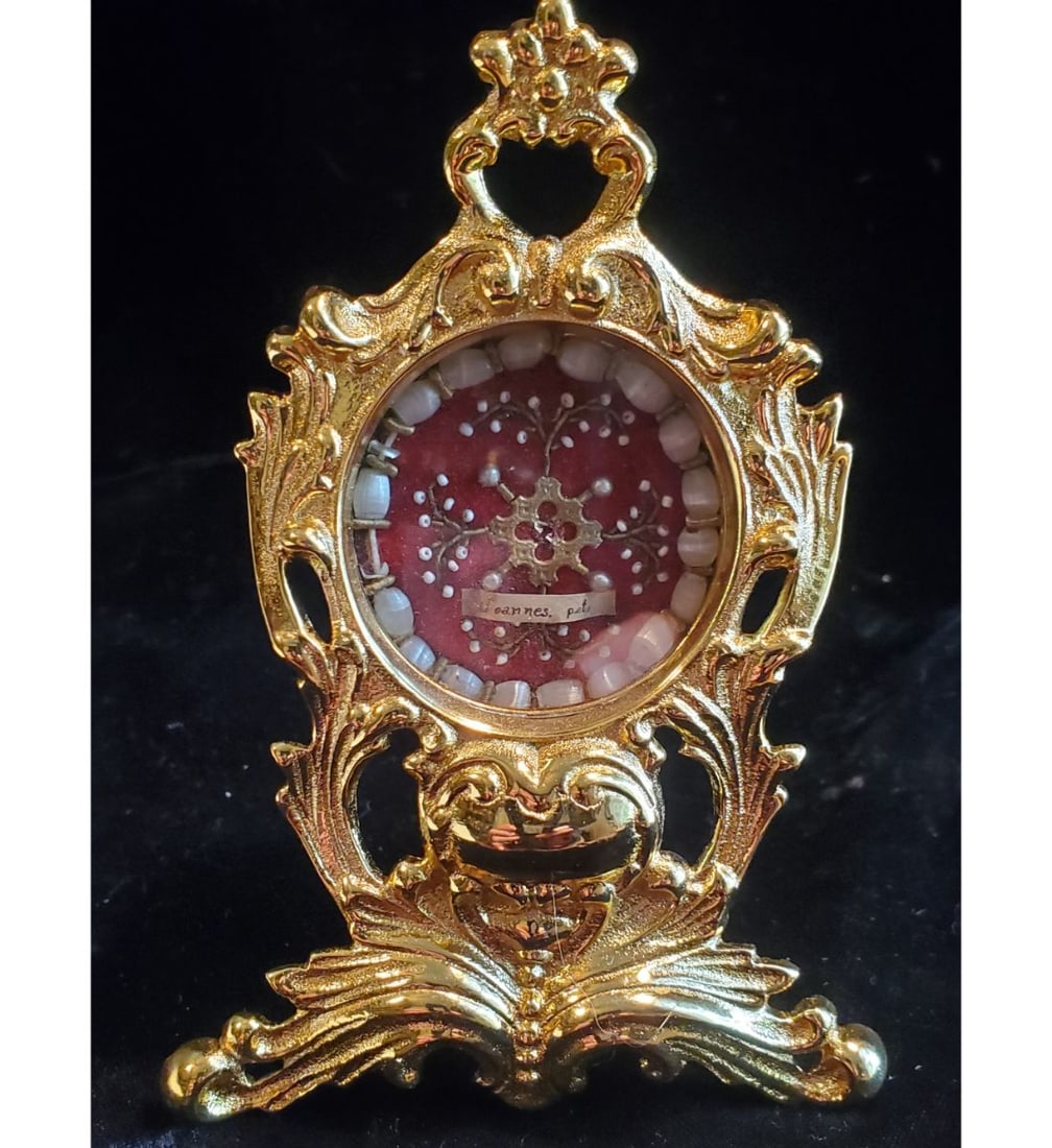 1st class relic of Saint Joannes with authentication document dated 1959: 1st class relic of Saint Joannes with authentication document dated 1959. The relic ex. Ossibus (bone) and surrounded by wonderful nuns artwork contained within an extra large Baroque faced reliquary.