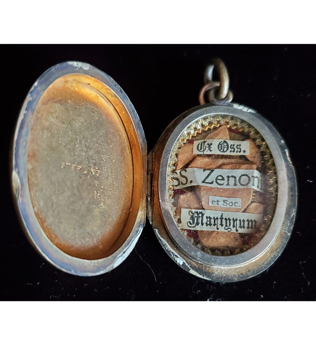 A Grand Sterling Silver Large Relic Of Saint Zeno And His Companions: A grand sterling silver large relic of Saint Zeno and his companions. The relics are ex. Ossibus (bone), and housed in a very large sterling silver theca. The theca is 2 1/2" by 1 1/2" in a closeable 