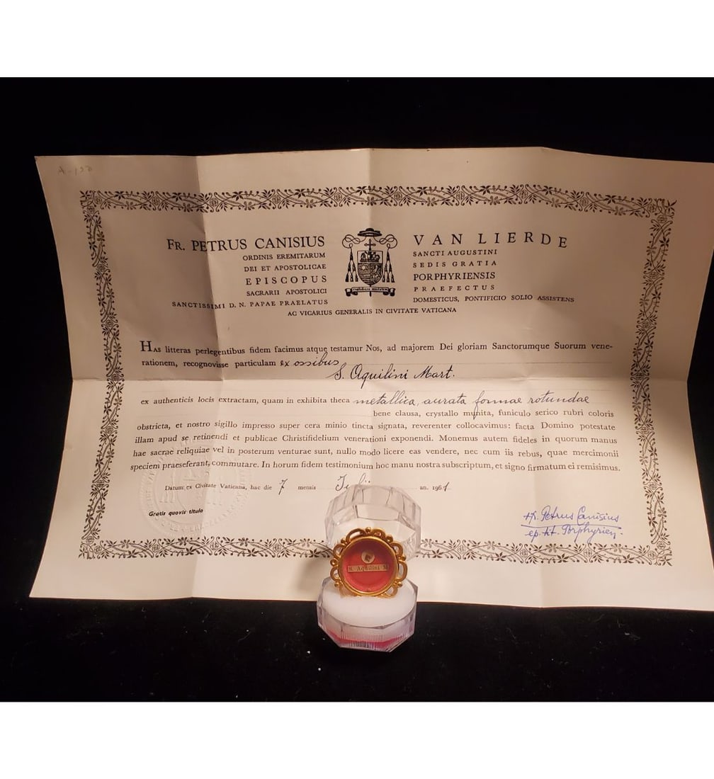 1st Class Relic Of Saint Aquilina, 3rd Century Martyr With Authentication Document Dated 1961: 1st class relic of Saint Aquilina, 3rd century Martyr with authentication document dated 1961. The relic is contained in a fancy gold theca. The theca is housed in an acrylic Gothic type presentation 
