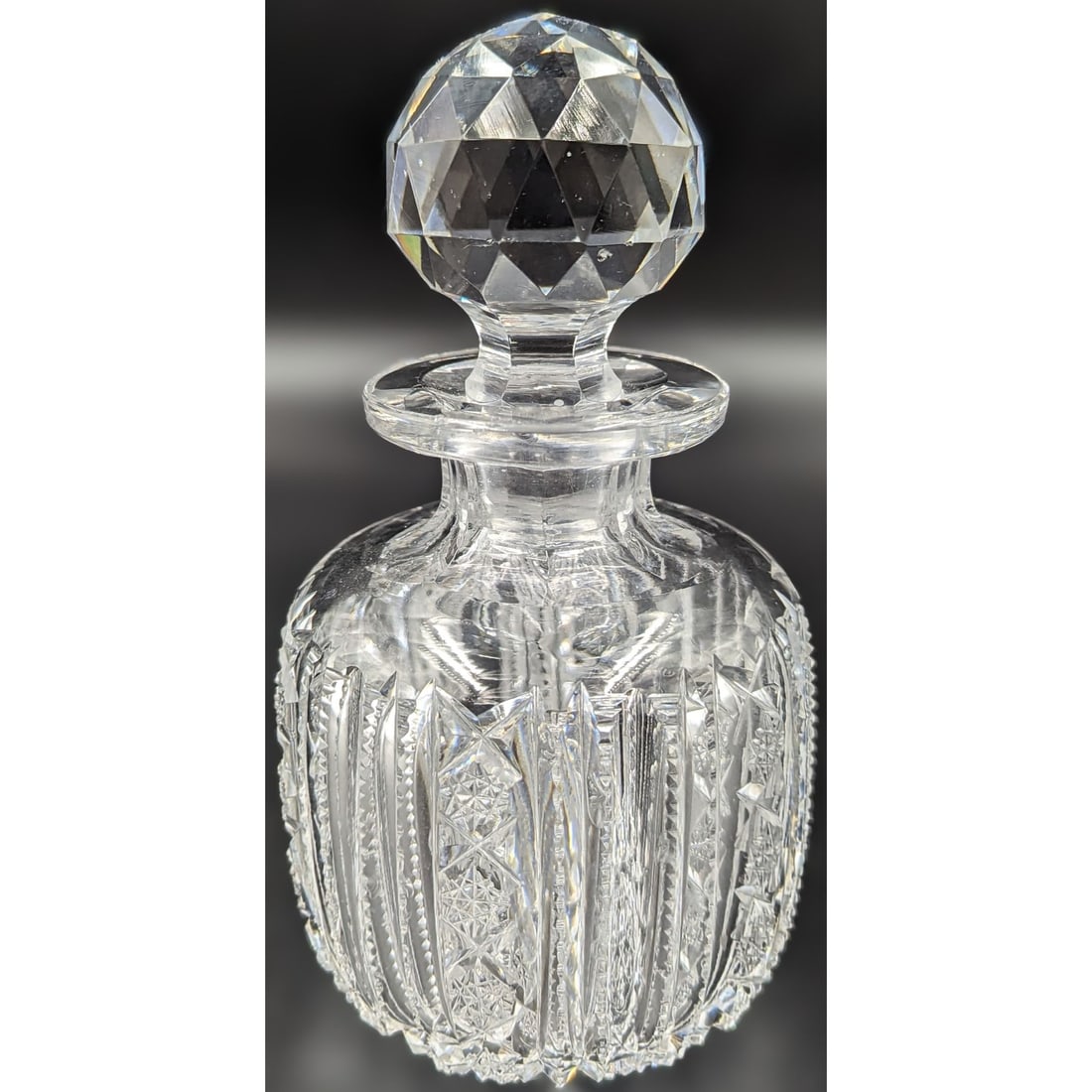 ABP Cut Glass Cologne, Fantastic Geometric Cut Design Which Extends Across The Bottom: ABP Cut Glass Cologne, Fantastic Geometric Cut Design Which Extends Across The Bottom. Measures approx. 6 1/2" tall and 3" in diameter. There is a major chip on the bottom of the stopper, please see p