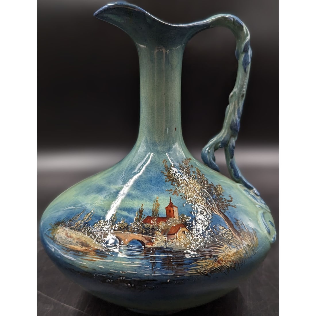 Grandmaster George Jones Majolica Pottery Ewer With Hand Painted Landscape Scene, Marked: Grandmaster George Jones Majolica Pottery Ewer With Hand Painted Landscape Scene, Marked. Measures approx. 9" tall. This piece is among the rarest of the art pottery lines as it is "Cyprian" ware. ||