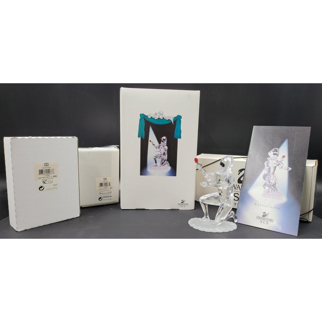 Swarovski SCS Harlequin Figurine & Plaque With Original Case And COA, With Welcome Gift: Swarovski SCS Harlequin Figurine & Plaque With Original Case And COA, With Welcome Gift. Measures approx. 5" X 3.75" X 2.5" || Please carefully read our terms of sale, shipping information, and reques