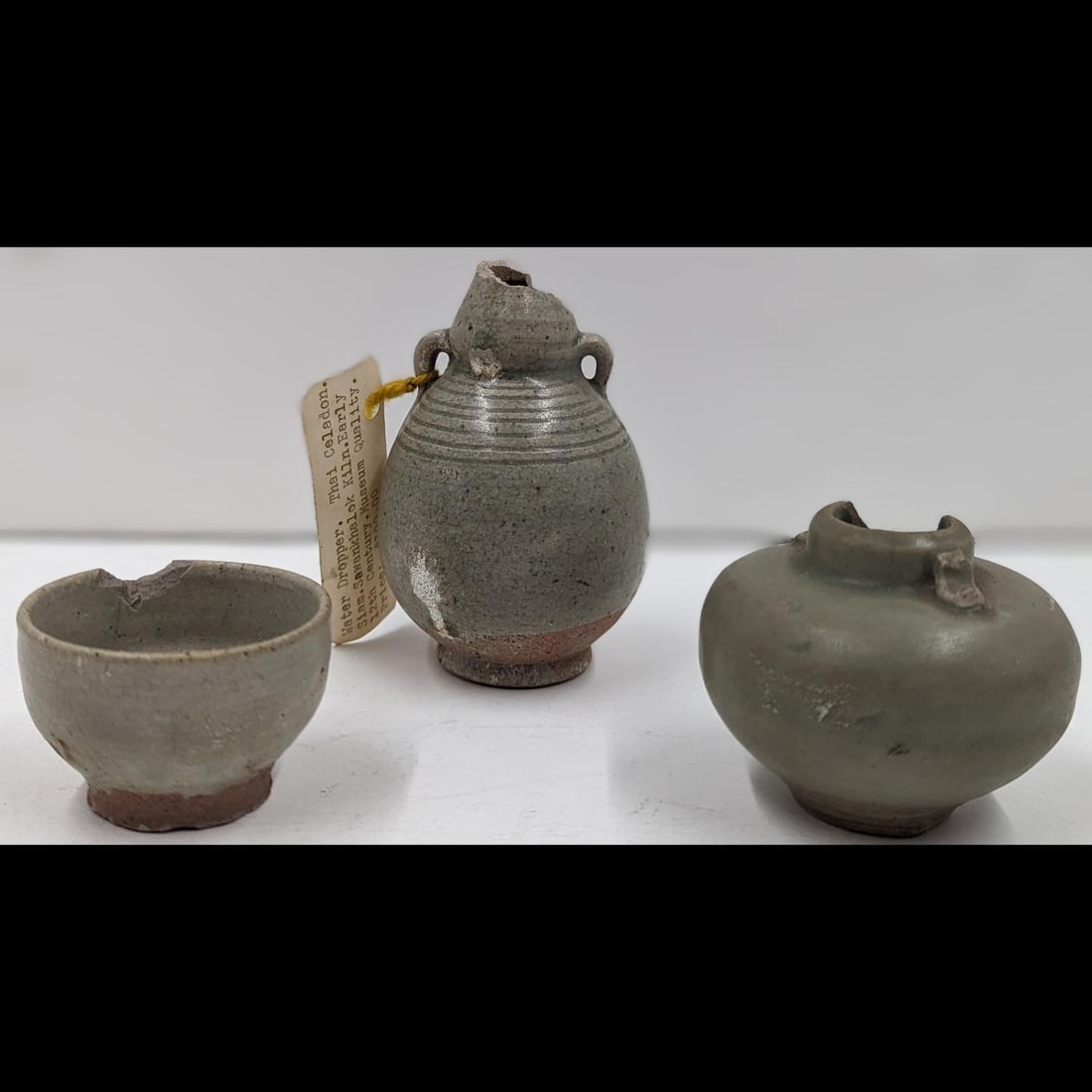 Lot Of 3 Thai Celadon Sawankhalok Pottery Vessels, Likely 12th Century: Lot Of 3 Thai Celadon Sawankhalok Pottery Vessels, Likely 12th Century. Measures approx. from 1 1/2" X 2 1/4" to 4" X 2 1/2". Please copy and paste the URL link below to review our Terms and
