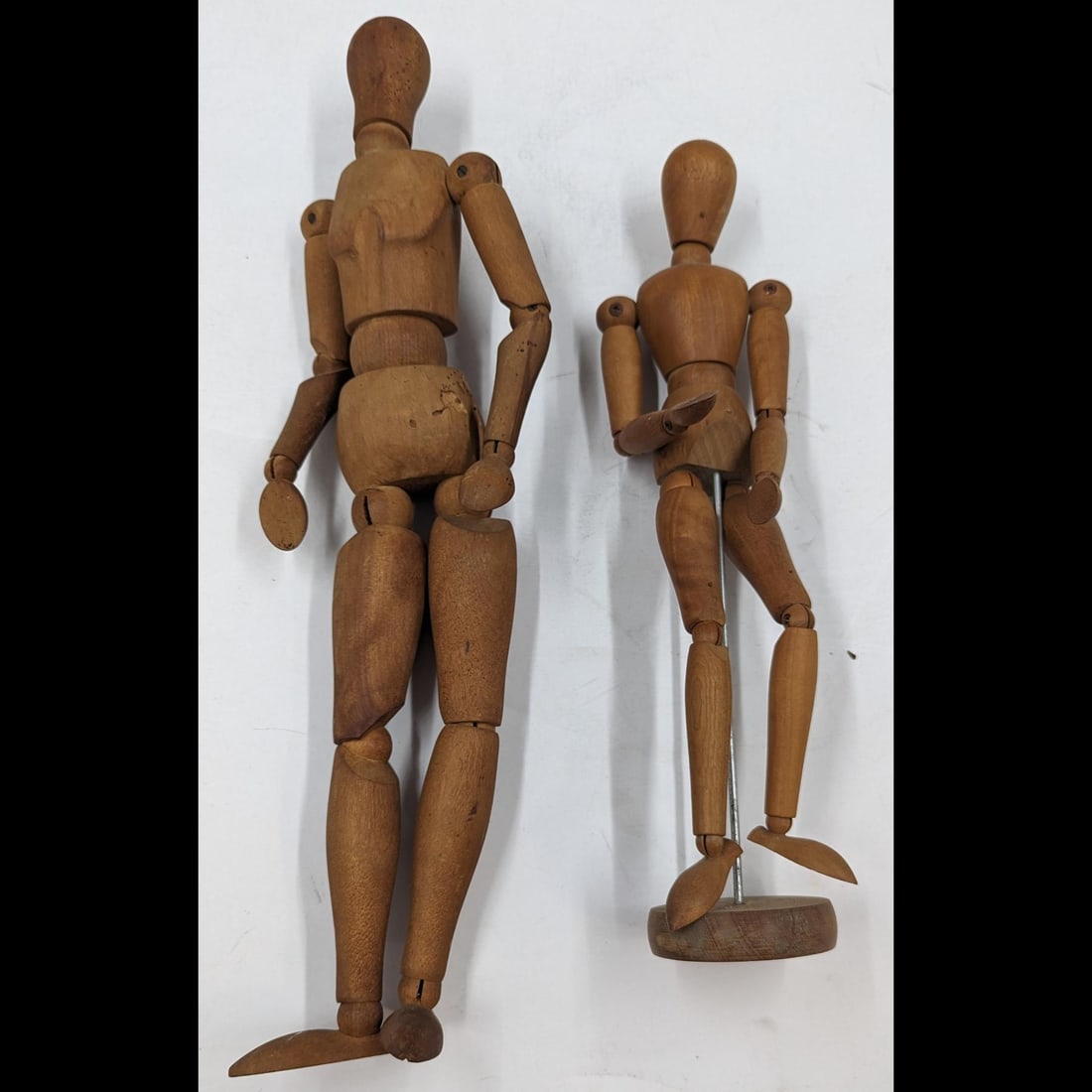 Pair of Vintage Articulated Wooden Art Mannequins: Pair of Vintage Articulated Wooden Art Mannequins. Measures approx. 12 1/2" X 3 and 15 1/2" X 4". Please copy and paste the URL link below to review our Terms and Conditions for bidding, paym