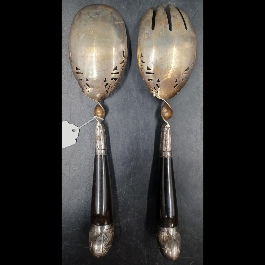 Pair Of Persian Silver Serving Utensils With Ebony Handles: (***DUE TO THIS ITEM BEING SILVER, ITEM MUST BE PAID WITH CERTIFIED CHECK OR BANK WIRE ONLY***) Pair Of Persian Silver Serving Utensils With Ebony Handles. Each measures approximately 10-1/2" long.