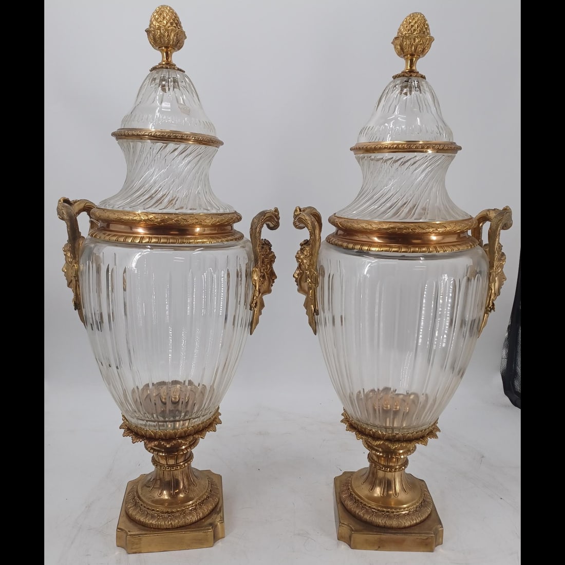 Large Pair Of French Baccarat-Style Urns Mounted On Gilt Bronze: Large Pair Of French Baccarat-Style Urns Mounted On Gilt Bronze. Each measures approximately 14" wide x 33" tall. Please copy and paste the URL link below to review our Terms and Conditions f