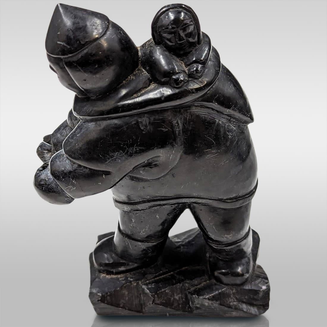 Alaskan Inuit Carved Soapstone Eskimo With Child: Alaskan Inuit Carved Soapstone Eskimo With Child. Measures approx. 6 1/2" X 4 1/2". Please copy and paste the URL link below to review our Terms and Conditions for bidding, payment, shipping