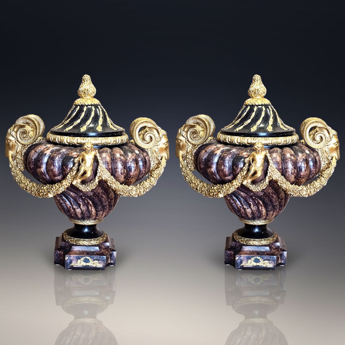 Pair Of French Style Faux Marble And Gilt Floor Vase Urns With Ram Heads And Cherubs: Pair Of French Style Faux Marble And Gilt Floor Vase Urns With Ram Heads And Cherubs. An absolutely incredible sight to be seen in person. Provenance: Central Florida Estate. Measures approx. 24" X 26