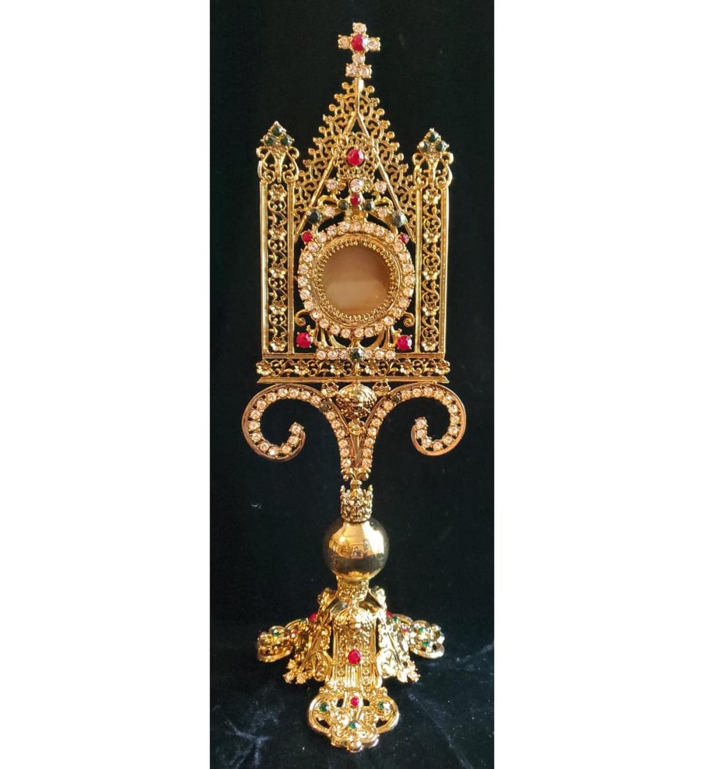 A Grand Cathedral Size Gothic Reliquary: A grand cathedral size Gothic reliquary. This reliquary stands 13" tall with intricate tracery work. It has been newly gold plated with approximately 100 glass jewels. In absolute mint condition, this