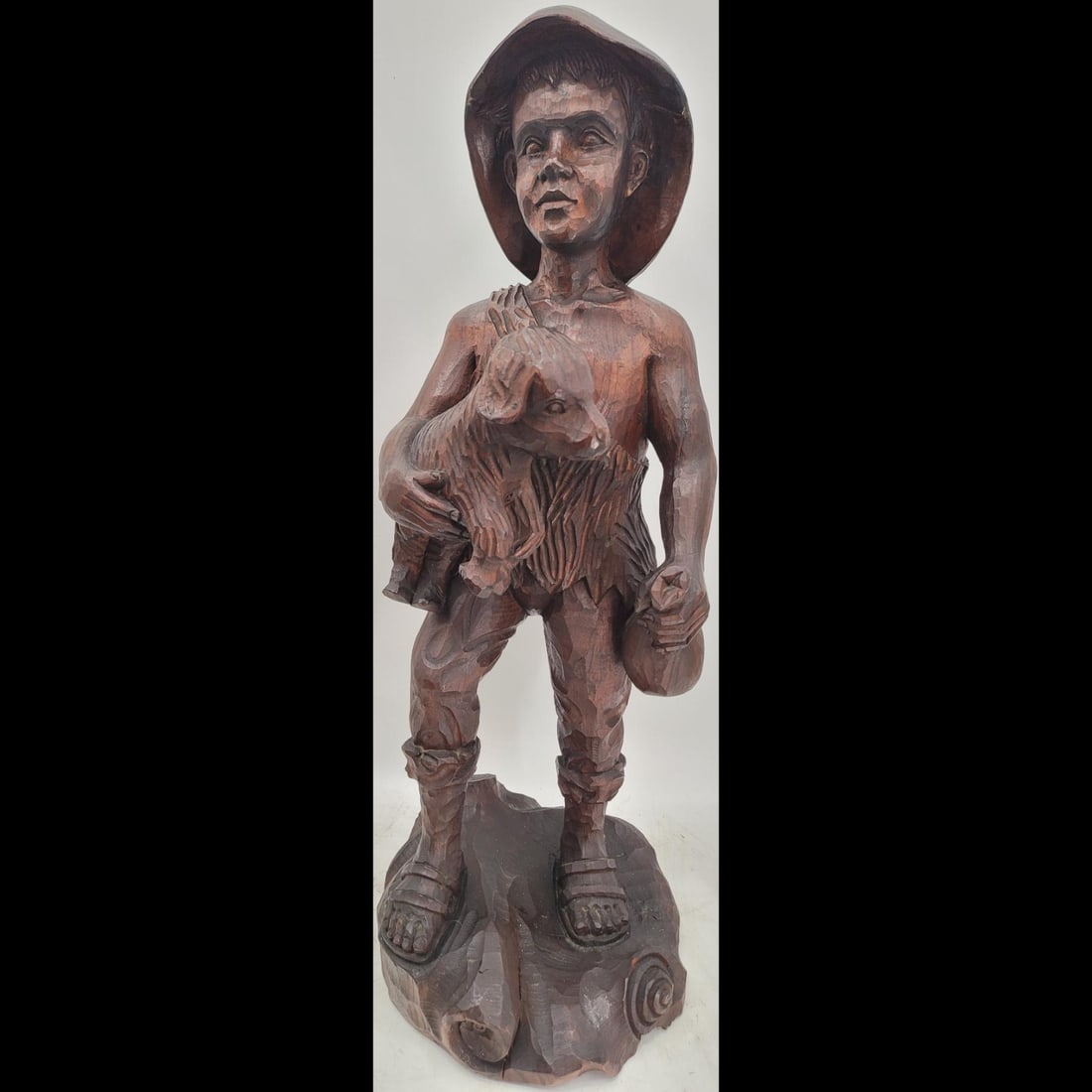 Black Forest Wood Carving Of Boy With Lamb: Black Forest Wood Carving Of Boy With Lamb. Measures approx. 31" X 11" X 12.5". Please copy and paste the URL link below to review our Terms and Conditions for bidding, payment, shipping an