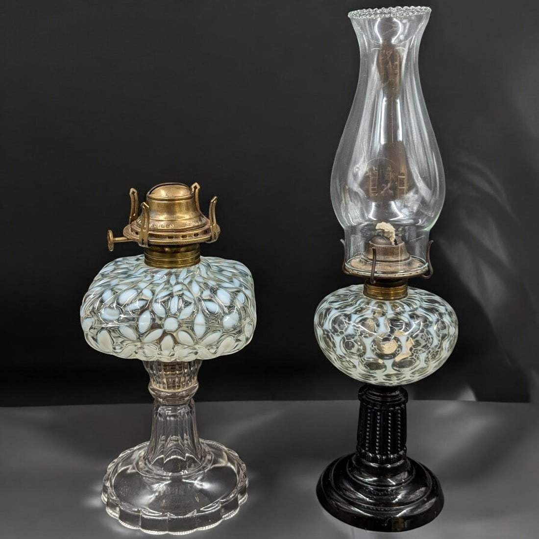 Pair Of Antique American Opalescent Glass Oil Lamps: Pair Of Antique American Opalescent Glass Oil Lamps. Measures approx. 10 1/2" X 5" and 16" X 4 1/2". Please copy and paste the URL link below to review our Terms and Conditions for bidding,