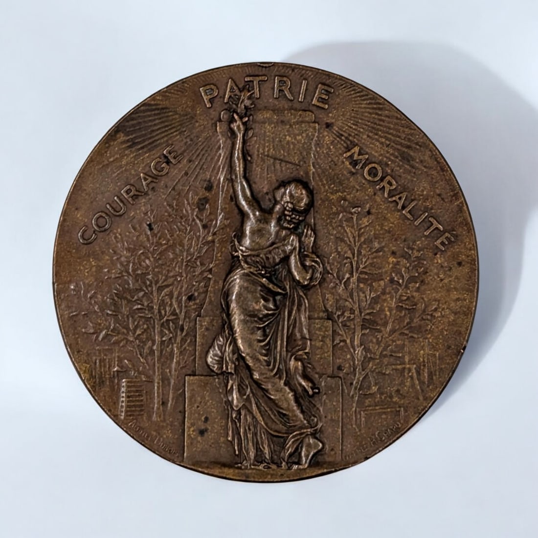 A Vintage French Bronze Gymnastics Medal By Alphee Dubois After Chapu: A Vintage French Bronze Gymnastics Medal By Alphee Dubois After Chapu. The back translates to "union of gymnastics societies of France, federal holiday". Measures approx. 2 1/4" in diameter.