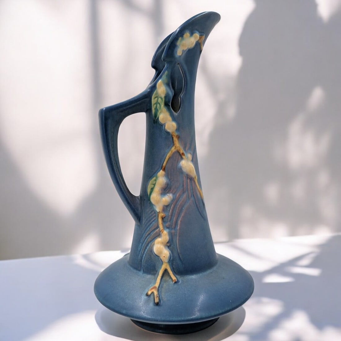 Vintage Roseville Pottery Blue Snowberry Ewer ITK-10: Vintage Roseville Pottery Blue Snowberry Ewer ITK-10. Measures approx. from 10 1/2" X 5 1/2". Please copy and paste the URL link below to review our Terms and Conditions for bidding, payment