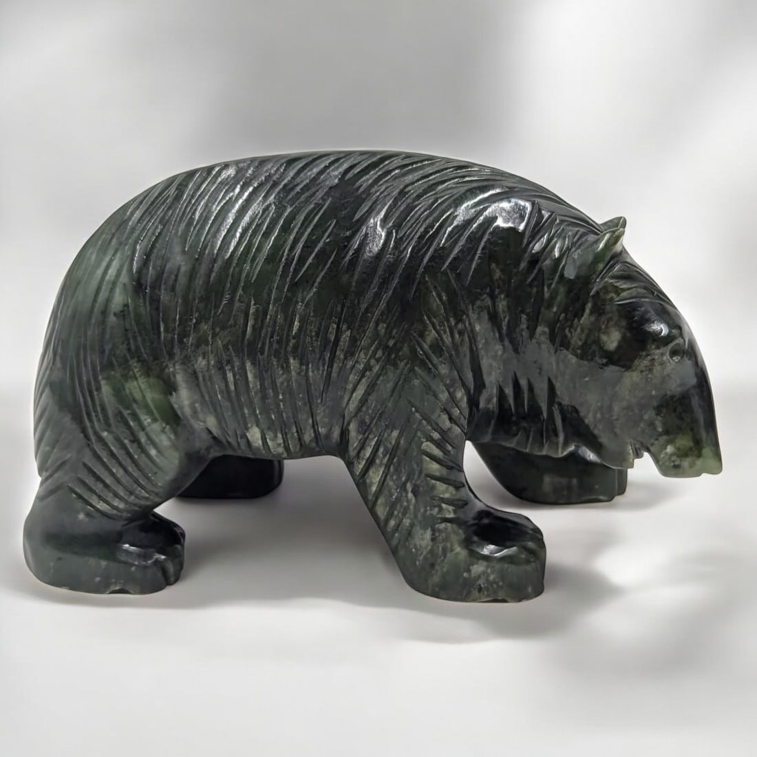 A Very Finely Carved Nephrite Jade Bear: A Very Finely Carved Nephrite Jade Bear. Measures approx. 3" X 5". Please copy and paste the URL link below to review our Terms and Conditions for bidding, payment, shipping and other specif
