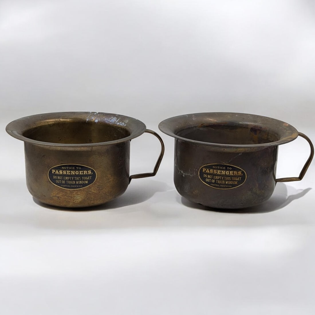 A Pair Of Old Central Pacific Railroad Brass Handled Chamber Pot: A Pair Of Old Central Pacific Railroad Brass Handled Chamber Pot. Measures approx. from 6" x 13". Please copy and paste the URL link below to review our Terms and Conditions for bidding, pa