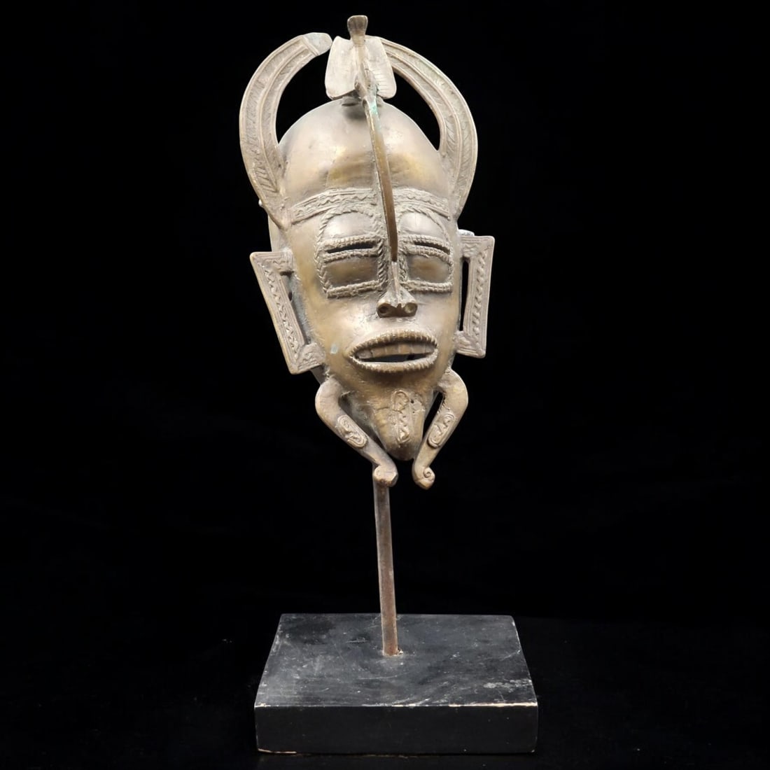 A Brass Senufo Kpeliye'e Mask, Ivory Coast: A Brass Senufo Kpeliye'e Mask, Ivory Coast. Measures approximately 15" x 5-3/4" x 5-3/4" Please copy and paste the URL link below to review our Terms and Conditions for bidding, payment, ship