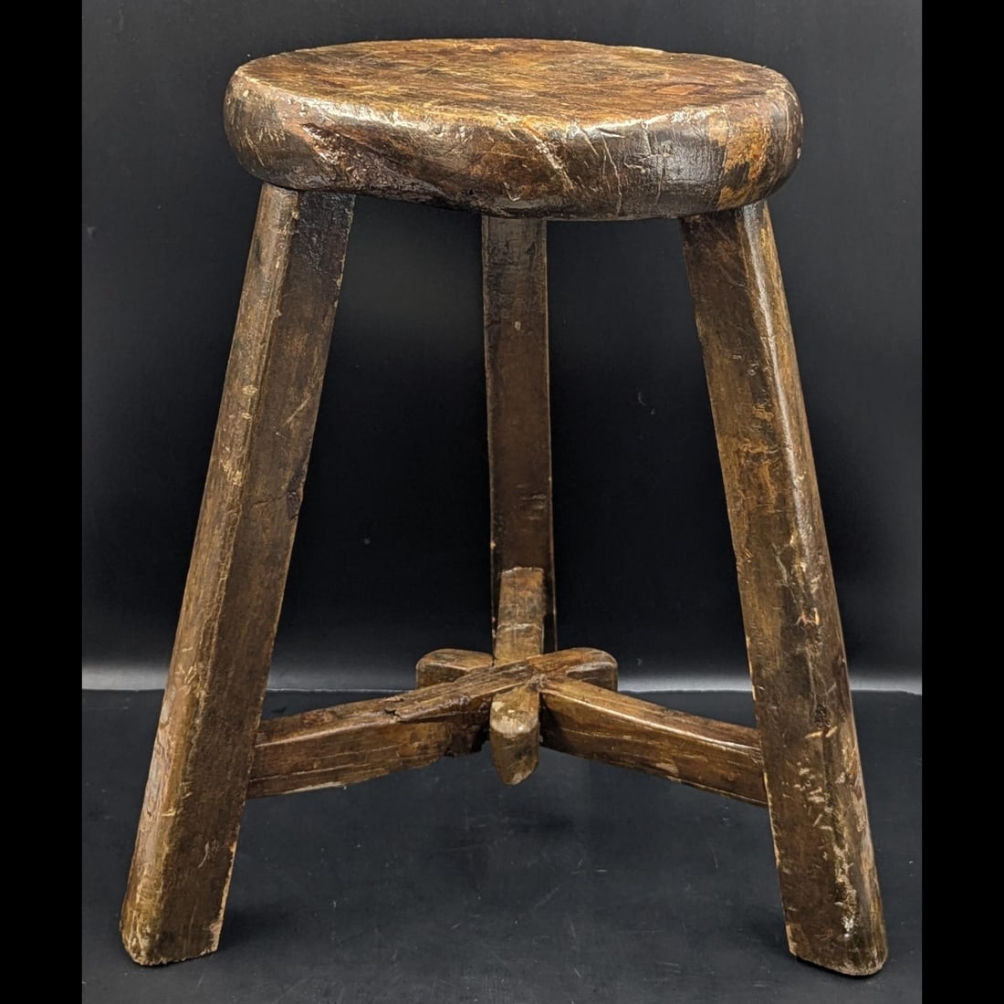 An Antique Carved Wood Three-Legged Stool, Possibly Elm, Likely Used As A Milking Stool: An Antique Carved Wood Three-Legged Stool, Possibly Elm, Likely Used As A Milking Stool. Measures approx. 17 1/2" X 16". Please copy and paste the URL link below to review our Terms and Con