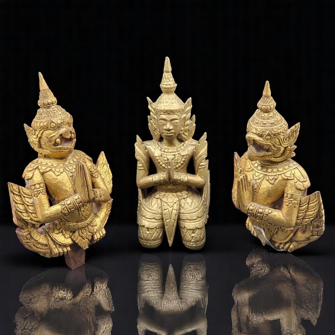 Trio Of Hand Carved Wooden Sculptures, A Buddhist & Garuda Pair: Trio Of Hand Carved Wooden Sculptures, A Buddhist & Garuda Pair. Buddhist measures approximately 10-1/4" x 4" and the Garuda pairs measure approximately 10" x 6" each. Please copy and paste t