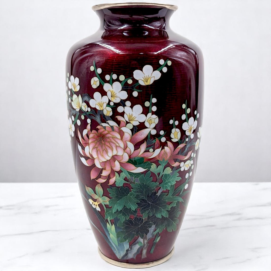 Vintage Japanese Red Cloisonne Vase With Floral Design: Vintage Japanese Red Cloisonne Vase With Floral Design. Measures approx. 9 3/4" X 5". Please copy and paste the URL link below to review our Terms and Conditions for bidding, payment, shipp