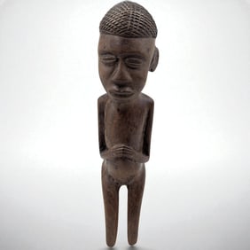 An African Carved Wood Sculpture Of A Kneeling Man