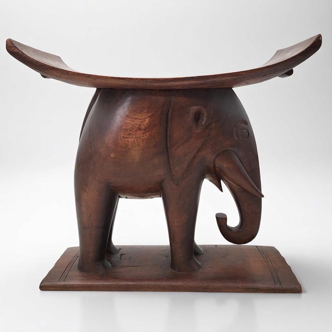 African Fanti Finely Carved Wood Elephant Seat: African Fanti Finely Carved Wood Elephant Seat. This is a type of folk art piece usually commissioned by wealthy colonists. Please note that the elephant tusk has MINOR DAMAGE - please see photographs