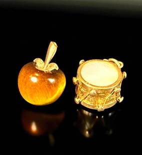 Lot Of Two 14K Gold Charms, A Drum And An Apple: ***DUE TO THIS LOT BEING GOLD IT MUST BE PAID VIA BANK WIRE TRANSFER OR CERTIFIED CHECK*** Two pieces 14k gold charms. First a charm in the form of a drum with mother of pearl. Marked 14k. Second a ti
