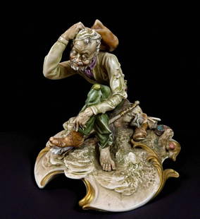 Antonio Borsato 1911-82 Italian Porcelain Figure Titled "Foot Loose": The figurine depicts a seated vagabond or cowboy resting on a rocky outcrop, scratching his head and looking at his well-worn shoe. Artist and Origin:It was sculpted by Antonio Borsato (1919-1982) and