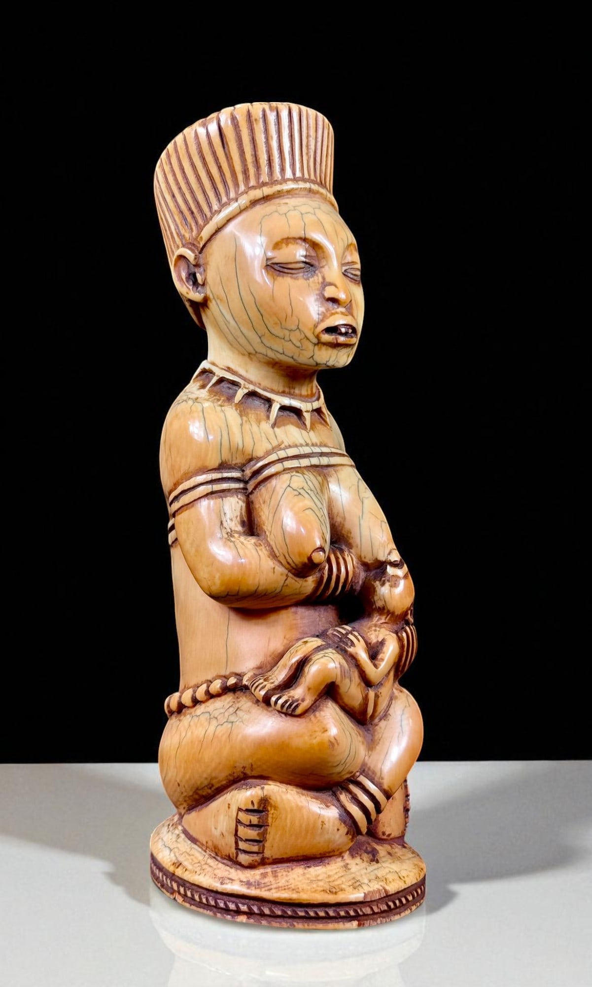 Museum Quality Carved Ethnographic Mother With A Nursing Infant: Truly an amazing ethnographic bone carved mother with nursing infant. Warm patina and evidence of significant age. Stands 8" tall. Excellent condition and a exceedingly rare museum quality piece. Plea