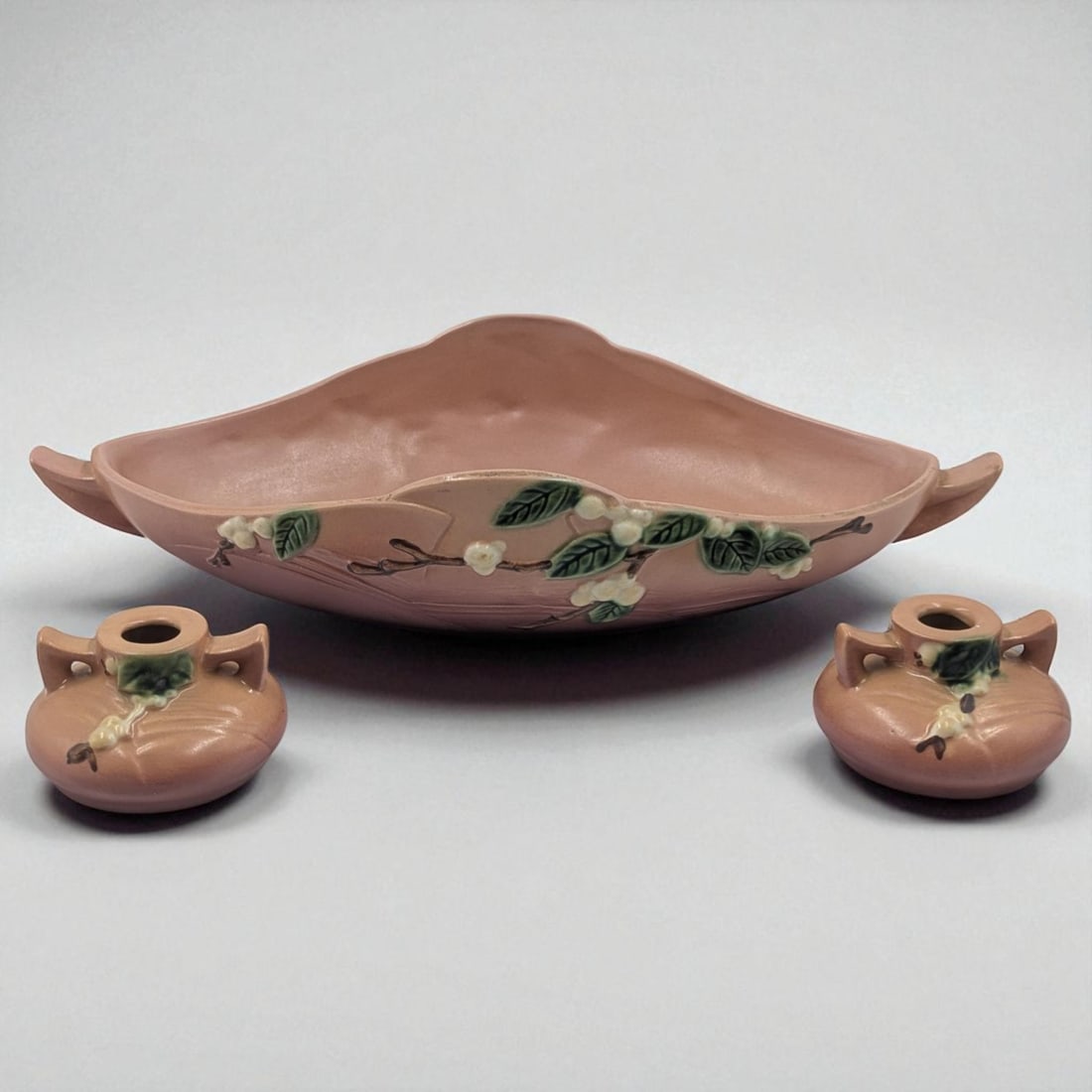 Lot Of 3 Vintage Roseville Pottery Pieces, Dusty Rose Snowberry Candlestick Holders And Console Bowl: Lot Of 3 Vintage Roseville Pottery Pieces, Dusty Rose Snowberry Candlestick Holders And Console Bowl. Candlestick holders measure approx. 2" 3 1/2". Console bowl measures approx. 3 1/2" X 17 1/2".