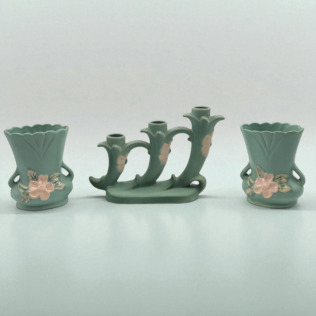 Lot Of 3 Vintage Weller Pottery Pieces, A Pair Of Turquoise Wild Rose Vases And Triple Candle Holder: Lot Of 3 Vintage Weller Pottery Pieces, A Pair Of Turquoise Wild Rose Vases And Triple Candle Holder. Candle holder measures approx. 6 1/2" X 10" and the vases measure approx. 5 1/4" X 4 1/4" each.