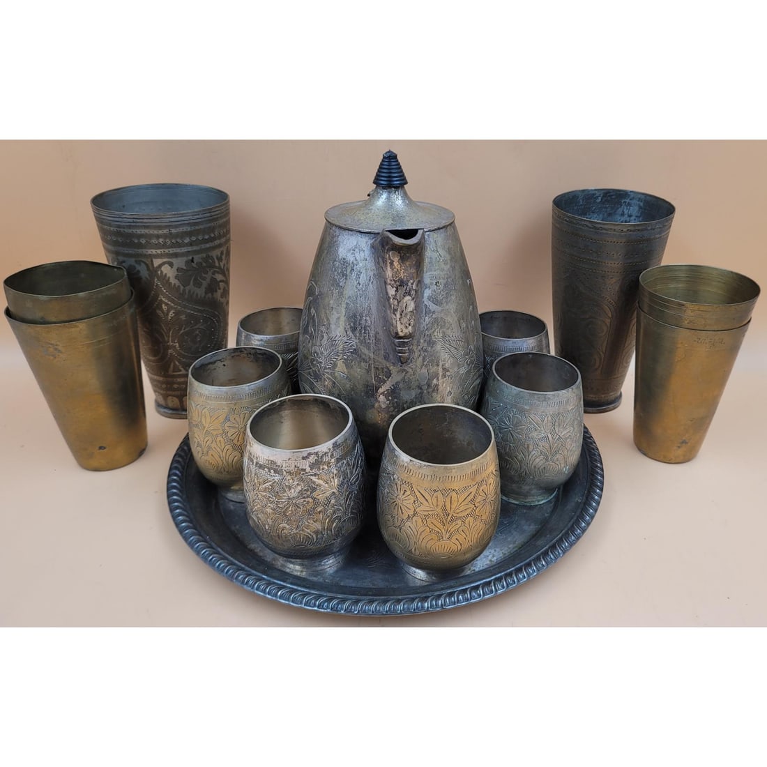 Middle Eastern Hand Chased Brass Tea And Cup Set: Middle Eastern Hand Chased Brass Tea And Cup Set. Measures approx. 9" X 8" X 5" to 4" X 3" X 3". Platter measures approx. 12.5" diameter. Please copy and paste the URL link below to review