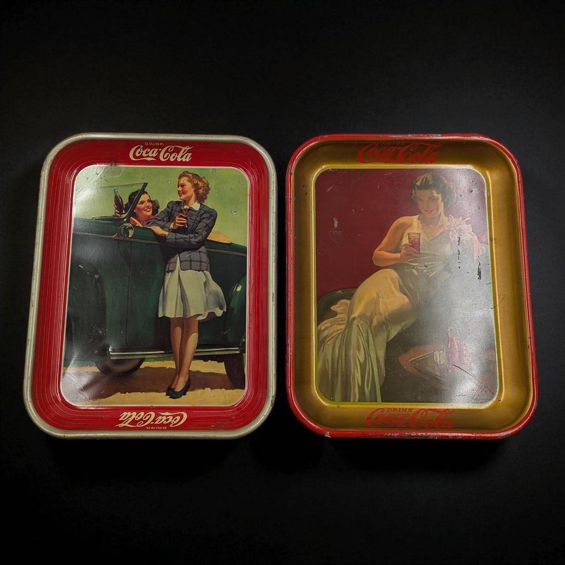A Pair Of Vintage Coca-Cola Advertising Tin Trays: A Pair Of Vintage Coca-Cola Advertising Tin Trays. Measures approx. 13 1/2" X 10 1/2" each. Please copy and paste the URL link below to review our Terms and Conditions for bidding, payment