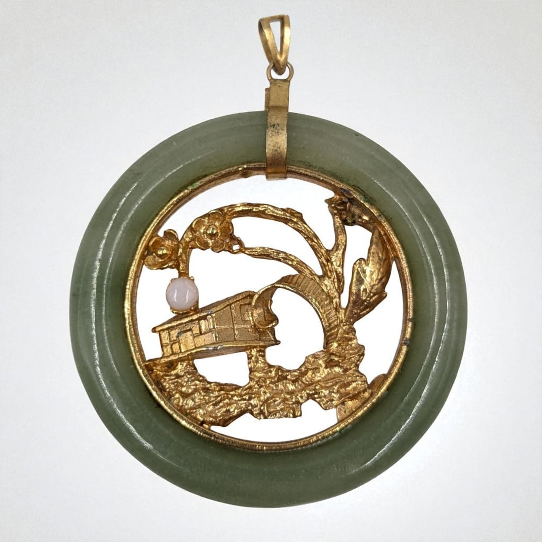 A Beautiful Vintage Chinese Scenic Jade Pendant With Gilt Metal And Moonstone: **DUE TO THIS LOT BEING JEWELRY IT MUST BE PAID VIA BANK WIRE TRANSFER OR CERTIFIED CHECK.** A Beautiful Vintage Chinese Scenic Jade Pendant With Gilt Metal And Moonstone. Measures approx. 2" in diame