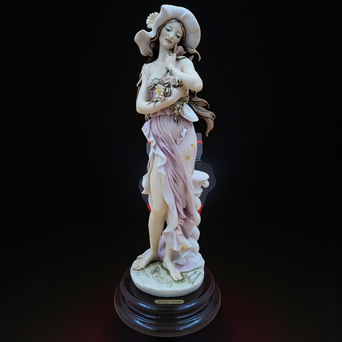 Giuseppe Armani Porcelain Figurine of a Lady with Hat and Flowers 202E "Daisy" 1994. Measures: Giuseppe Armani Porcelain Figurine of a Lady with Hat and Flowers 202E "Daisy" 1994. Measures approx. 14" X 5.5" X 5.5". Please copy and paste the URL link below to review our Terms and Co