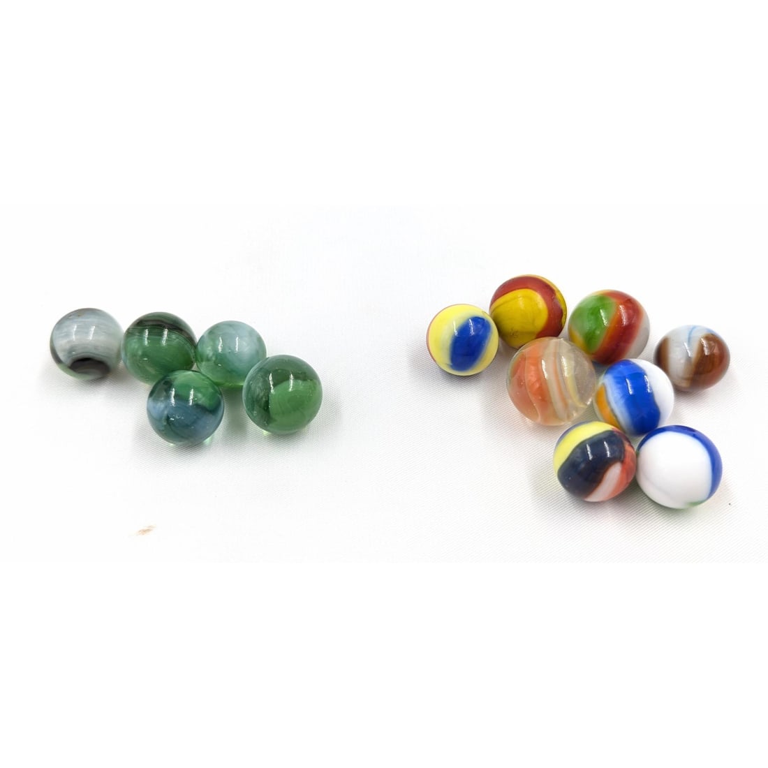 Marbles: Lot Of 13 Marbles In Two Groups, 5 Greenish Base Glass And 8 Corkscrews/Cat's-Eyes: Marbles: Lot Of 13 Marbles In Two Groups, 5 Greenish Base Glass And 8 Corkscrews/Cat's-Eyes. Bags measure approx. 3 1/2" X 2" each. Please copy and paste the URL link below to review o