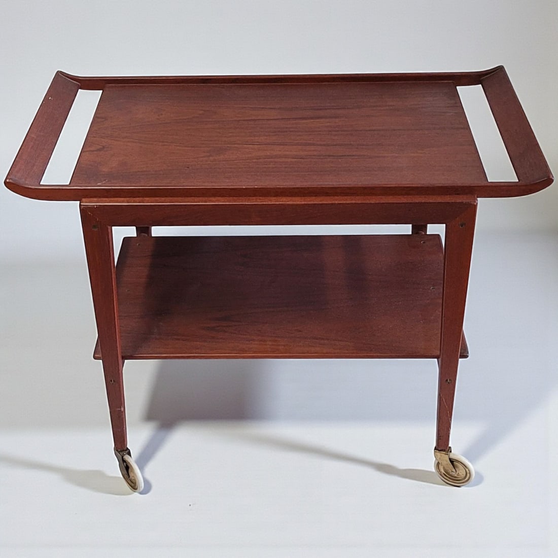 Mid Century Teak Two Tier Danish Trolley: Mid Century Teak Two Tier Danish Trolley. Measures approx. 27.5" X 35" X 19". Please copy and paste the URL link below to review our Terms and Conditions for bidding, payment, shipping and