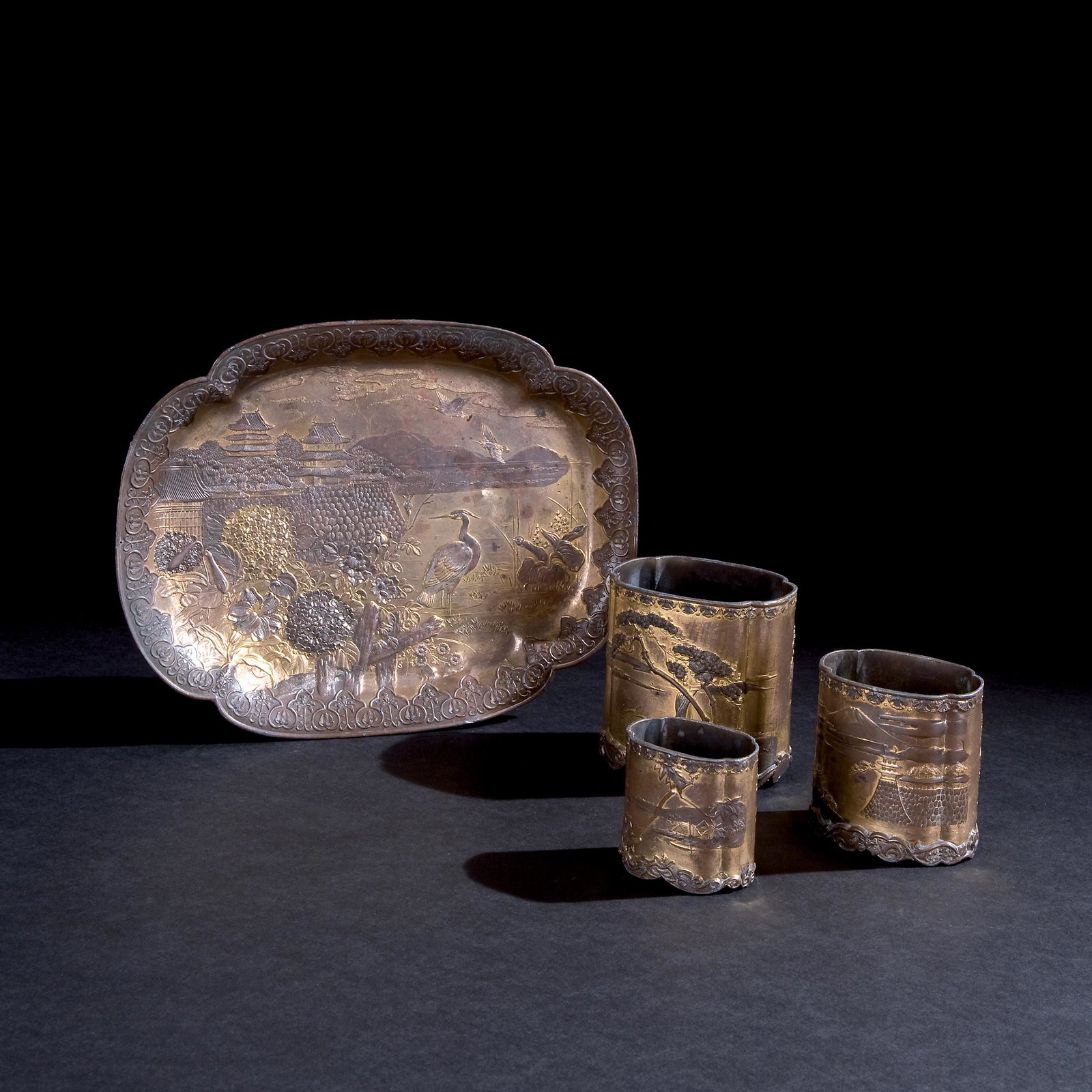 A gilt copper writing service, Japan, Meiji period: comprising 3 small containers and a tray, the tray 23by18cm.