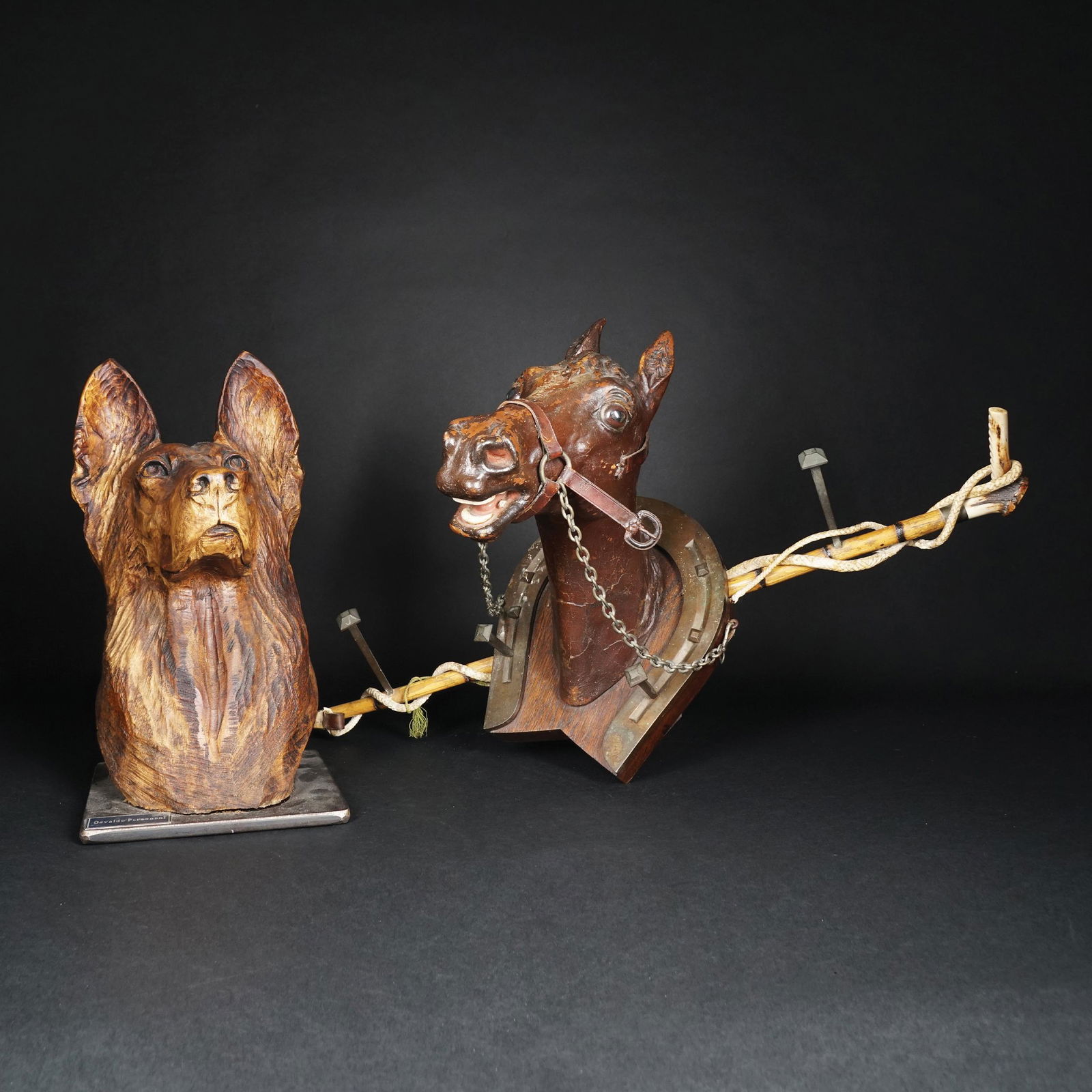 A polychrome wood horse head clothes hanger: TOGETHER WITH a wolfhound wood head, 76cm. long; 38,5cm. high