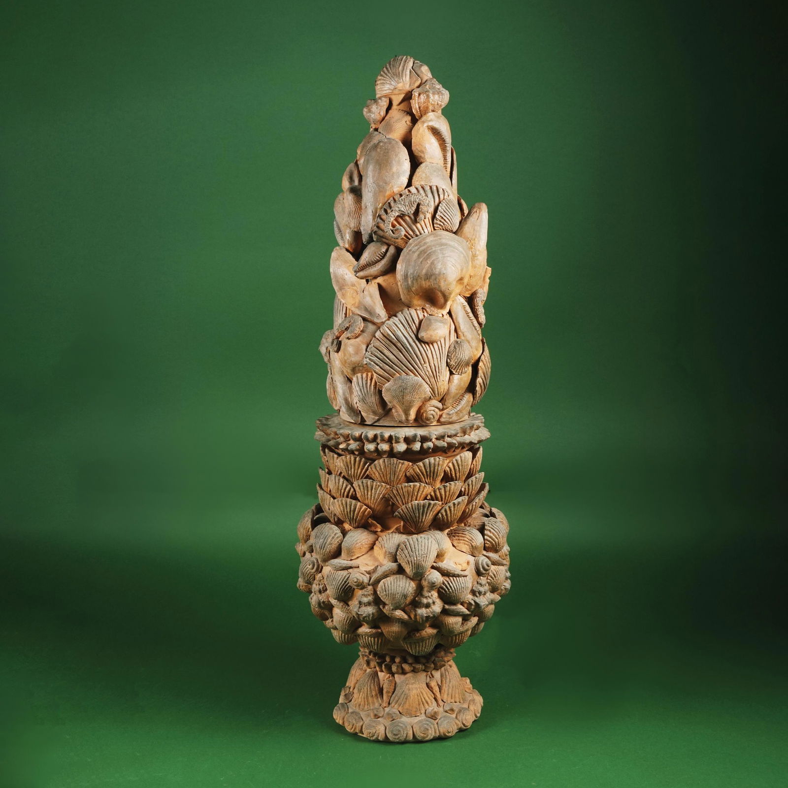 A terracotta potiche and cover modeled in shells: of different species, 68cm. high (chips)
