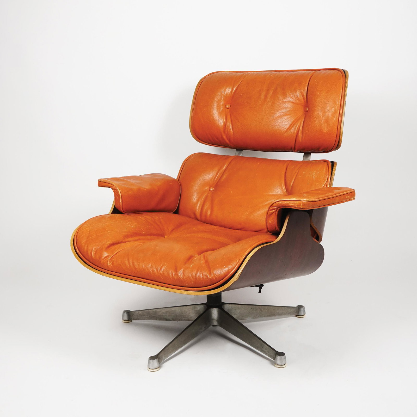 A metal and multilayer lounge chair: with leather pillows, Charles Eames for Hermann Miller, '60s, 84x80x87cm.