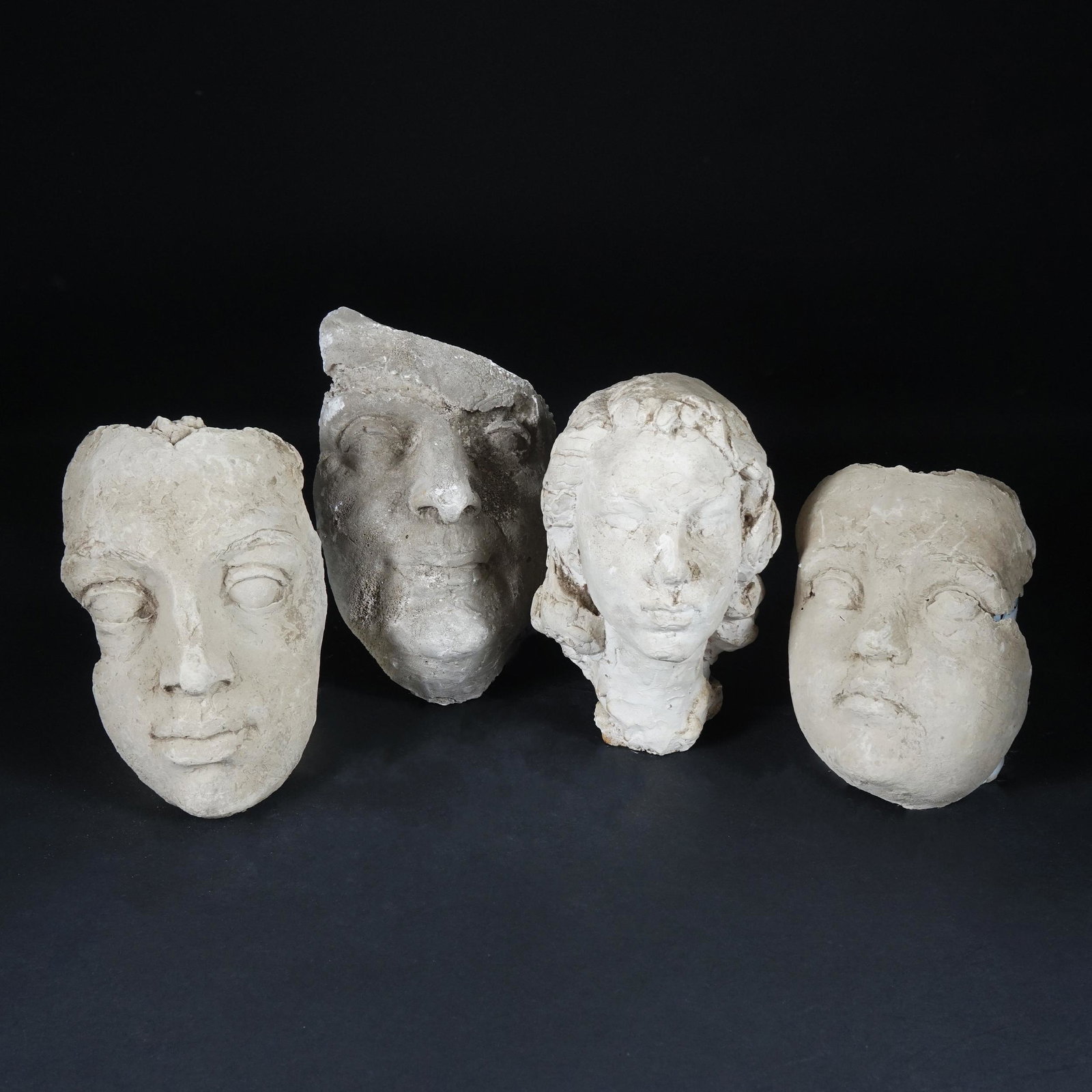 Assen Peikov (Sofia 1908 - Roma 1973): A plaster female head TOGETHER WITH 3 plaster masks the head 20cm. high, the masks from 18cm. to 23cm. long