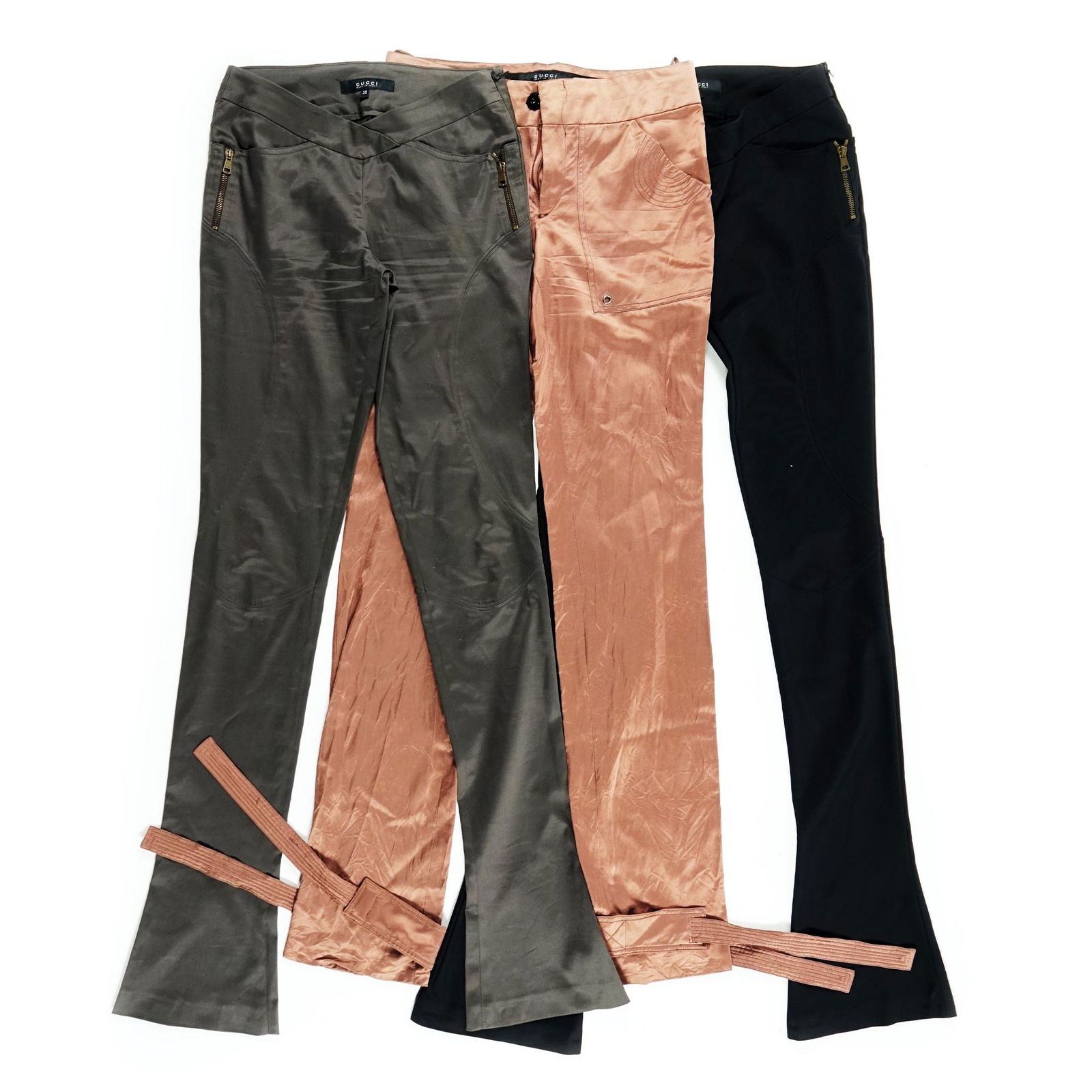 Gucci: two pairs of stretch trousers of the same model, respectively in military green and black TOGETHER WITH to another one in a copper-colored blend; all of size 38