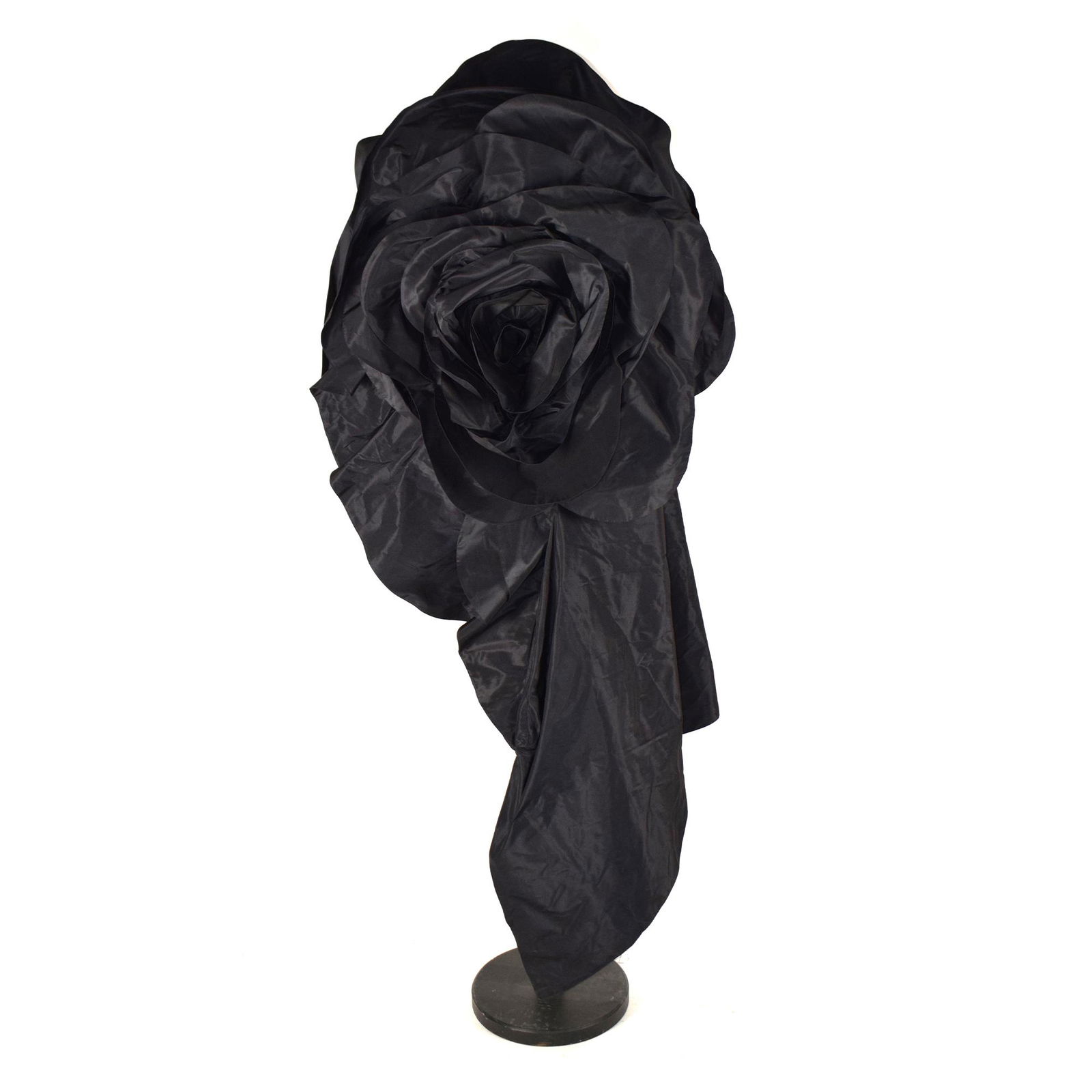 John Galliano: a black taffetÃ silk blend dress accessory with large flower, circa 130by80cm. (maximum aperture)