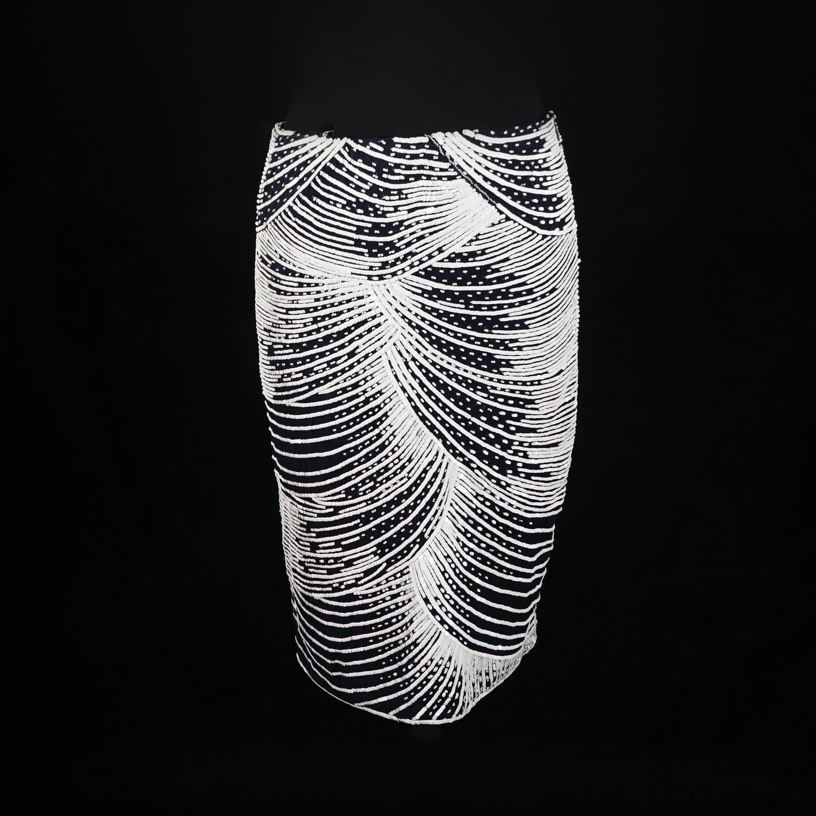 Valentino: a black silk skirt entirely embroidered with white sunburst sequins