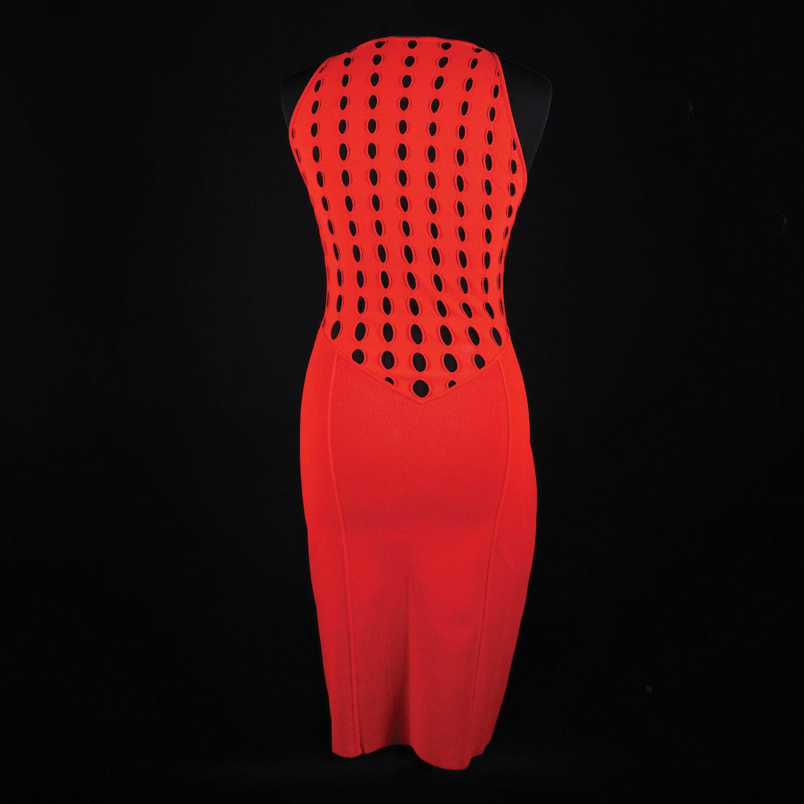 Gianni Versace: a sleeveless red viscose dress with partly perforated array. 1994