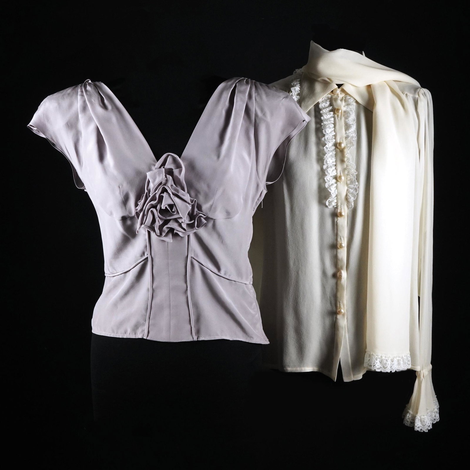 Yves Saint Laurent: an ivory silk and lace shirt with sash TOGETHER WITH a grey/lilac silk top
