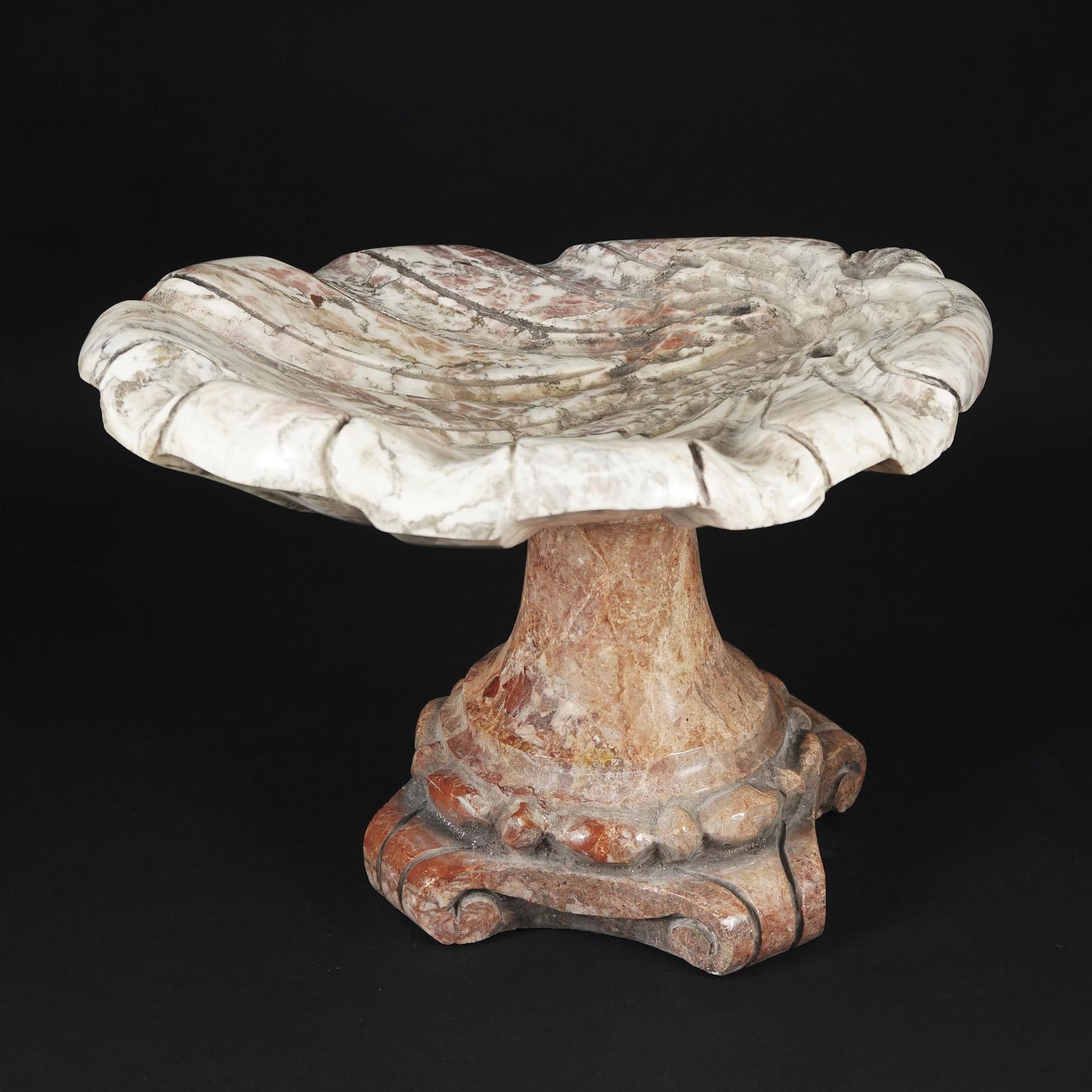 A polychrome marbles stand in the shape of a shell: 26x37x31cm.