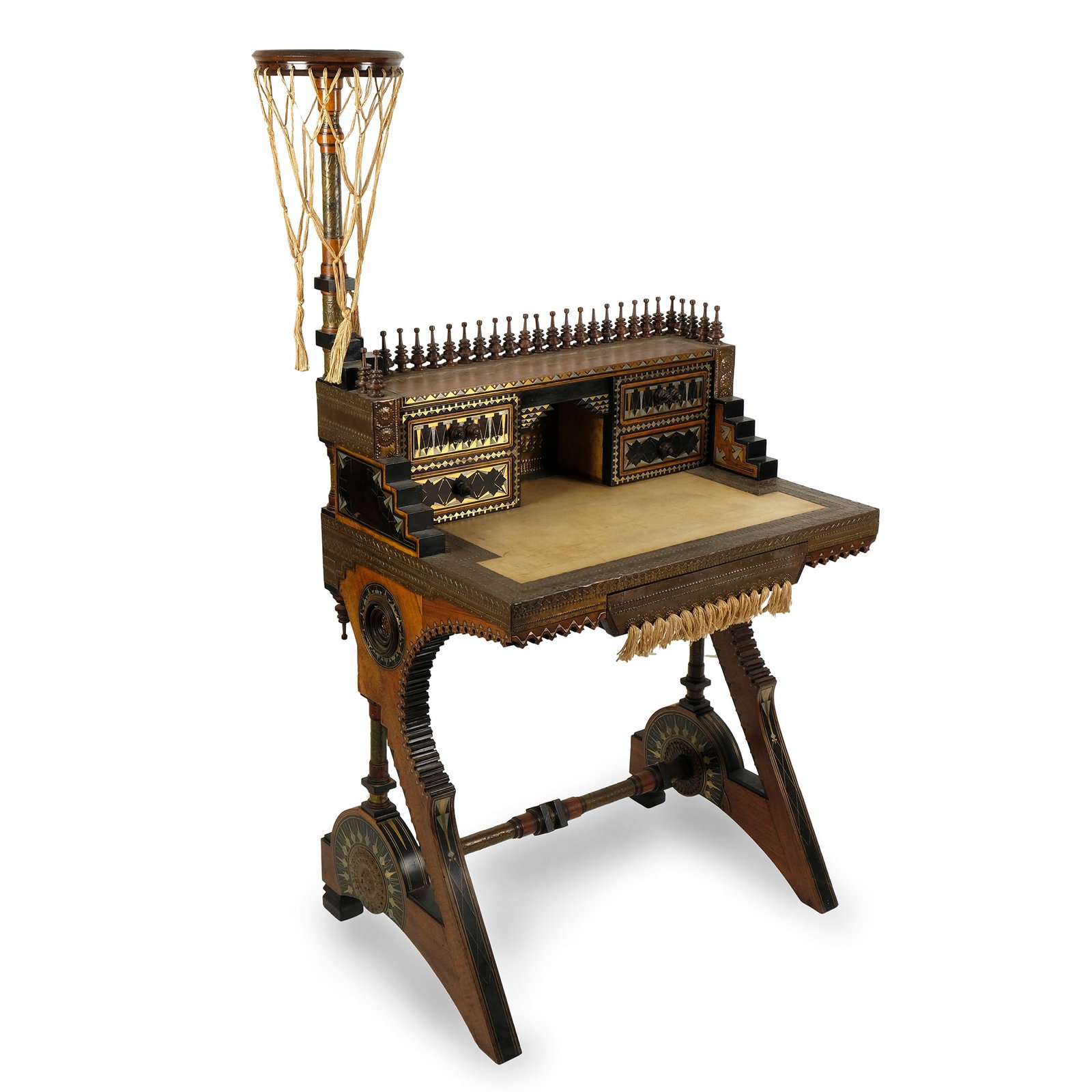 Carlo Bugatti: writing desk in natural wood and ebonized wood, inlaid with partially gilt pewter and bone. Top covered in parchment; a drawer on the band trimmed with tassels. Upper part with central compartment and