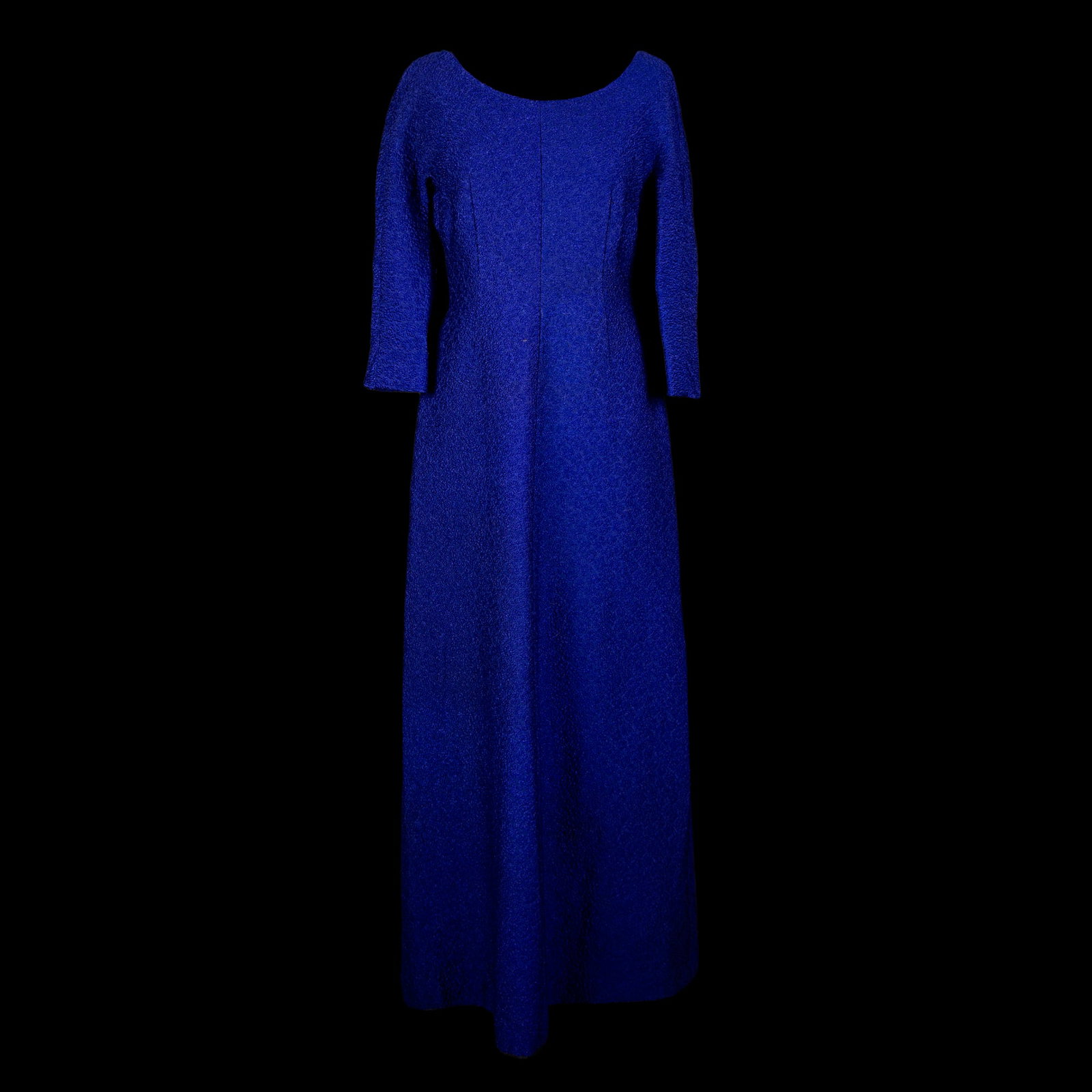 Long dress: bluette matelassé with dense and minute ornamental motifs; deep sweetheart neckline on the back.60's. Please note that each lot may have defects, stains or imperfections not noted in the catalog.