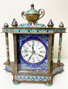 Antique table clock in enamel. The sides of the watch are decorated with: Antique table clock in cloisonne enamel. The sides of the watch are decorated with portraits of women. Copper, enamels, hand painting. Battery power system is integrated. The top of the clock is crown